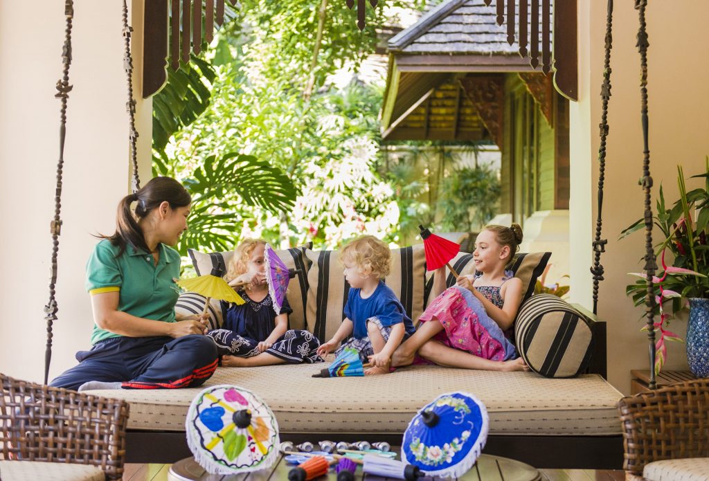 A woman sits with three children who are on a family wellness holiday at Four Season resort in Chiang Mai, Thailand.