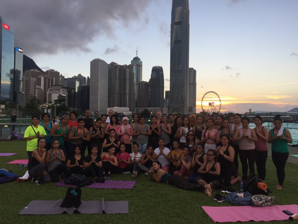 A group of people pose after a charity yoga class in Hong Kong