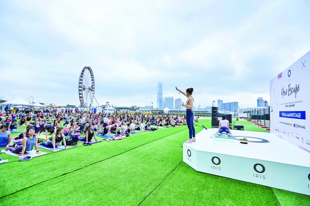 A woman leads a yoga class at IRIS wellness festival in Hong Kong