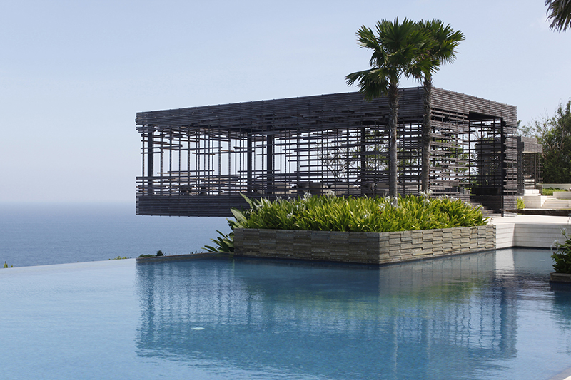 An infinity pool overlooking the ocean at Alila Villas Uluwatu, a wellness retreat in Bali.