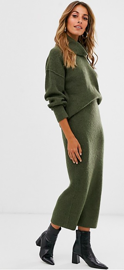 A woman in a green knitted co-ord made with recycled yarns, from ASOS.