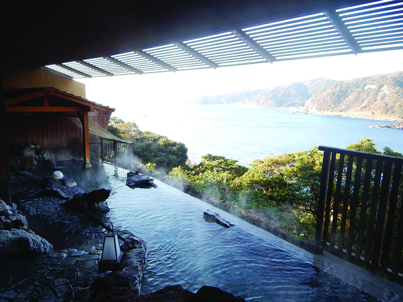 An onsen, or natural hot spring, with a view of the coastline. A popular wellness experience to try in Tokyo. 