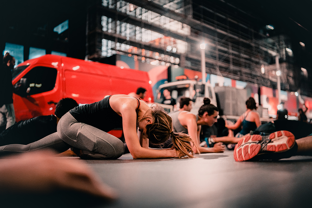 A woman stretches during a free workout class offered by Midnight Runners in Hong Kong. 