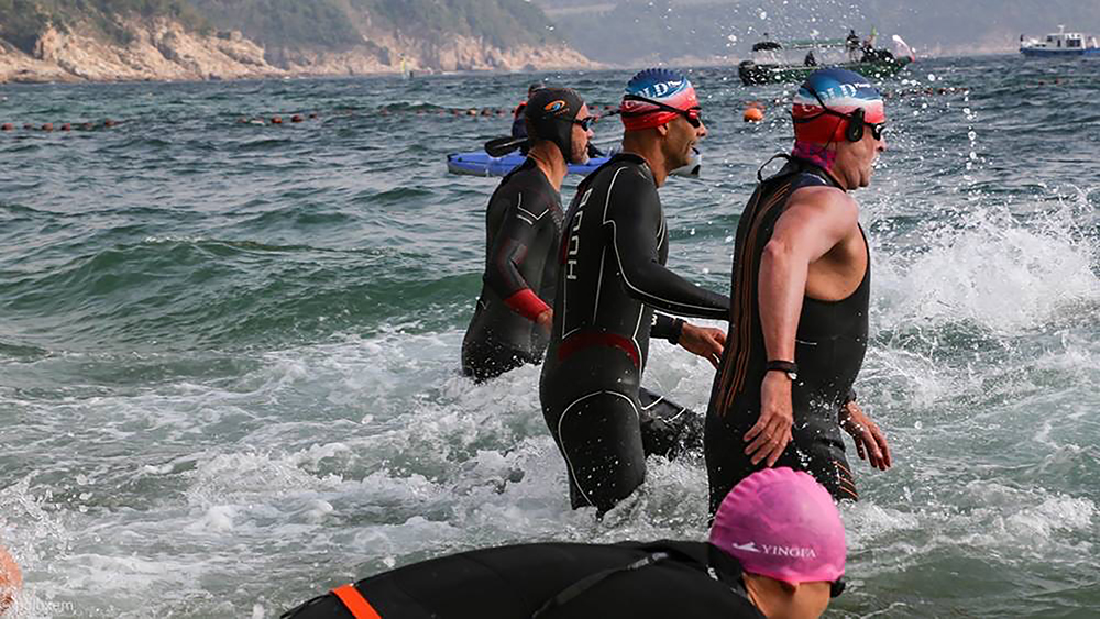 Swimmers enter the sea for the Cold Half, a wellness event and race that takes place in Hong Kong in January. 