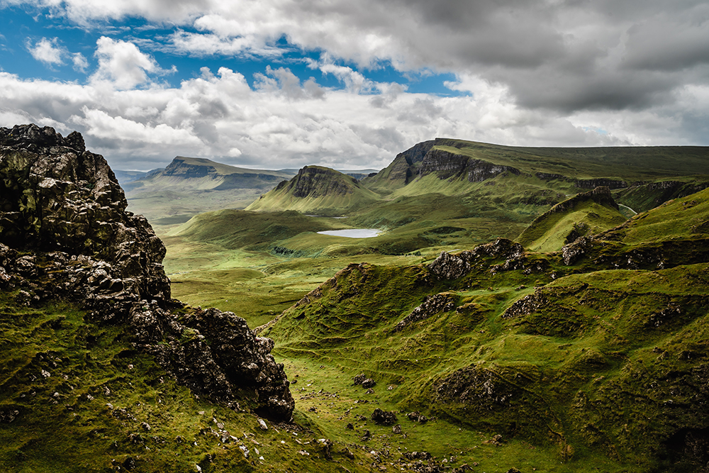 A dramatic green landscape from the countryside of Skye in the Scottish Highlands.