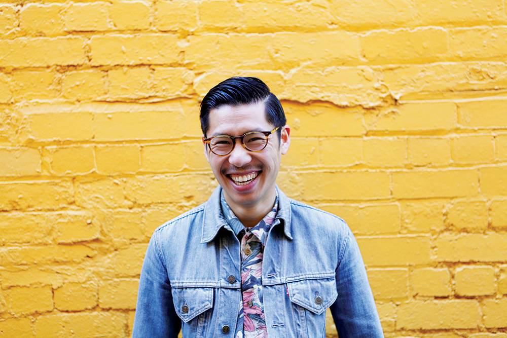 A man laughs on a yellow wall, part of the Movember campaign to raise awareness of men's health.