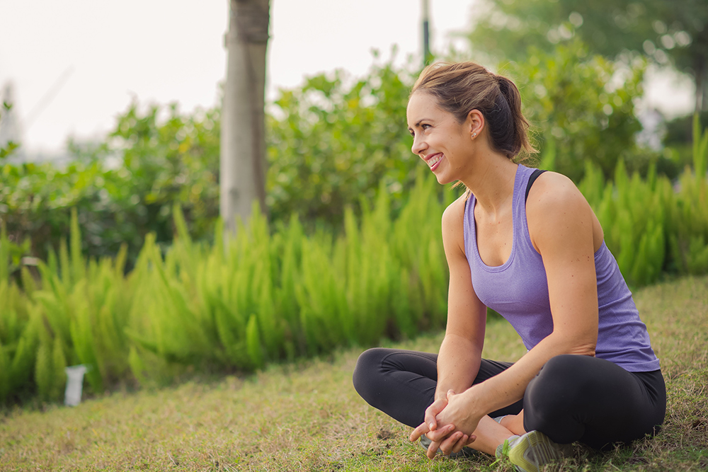 A photo of Hong Kong nutritionist Chrissy Denton sitting on the grass