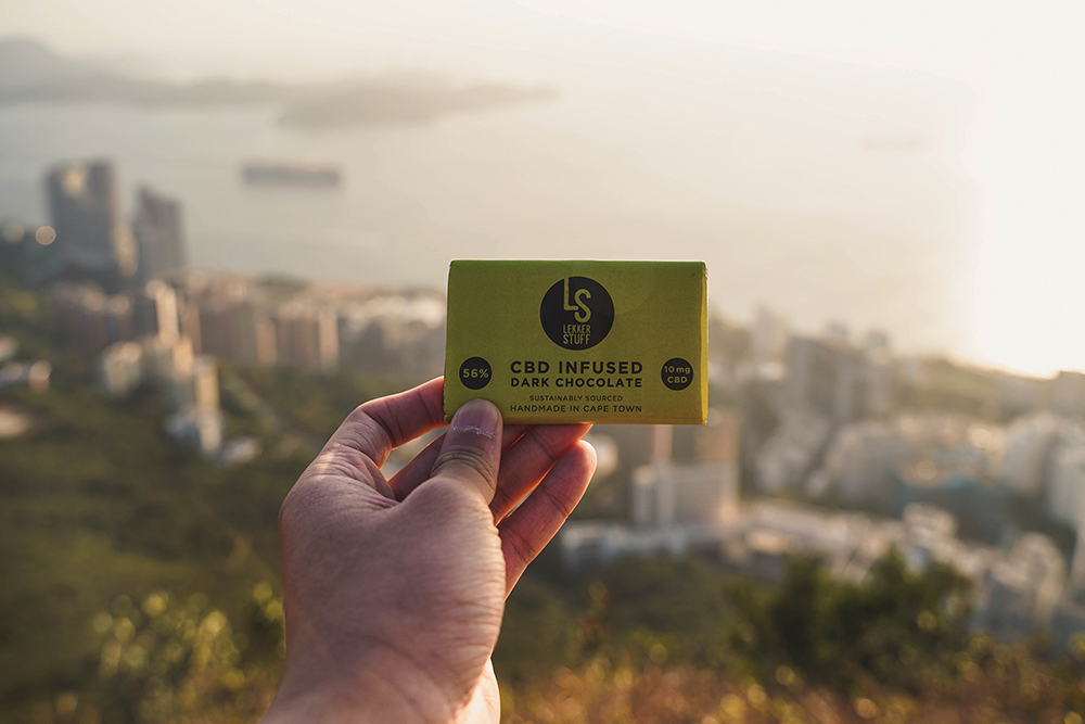 A photo of a CBD chocolate bar with Hong Kong in the background